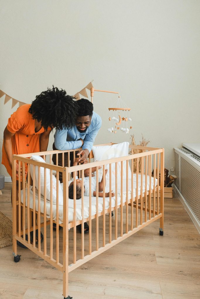 A joyful moment with parents are talking to your baby in a cozy nursery setting.
