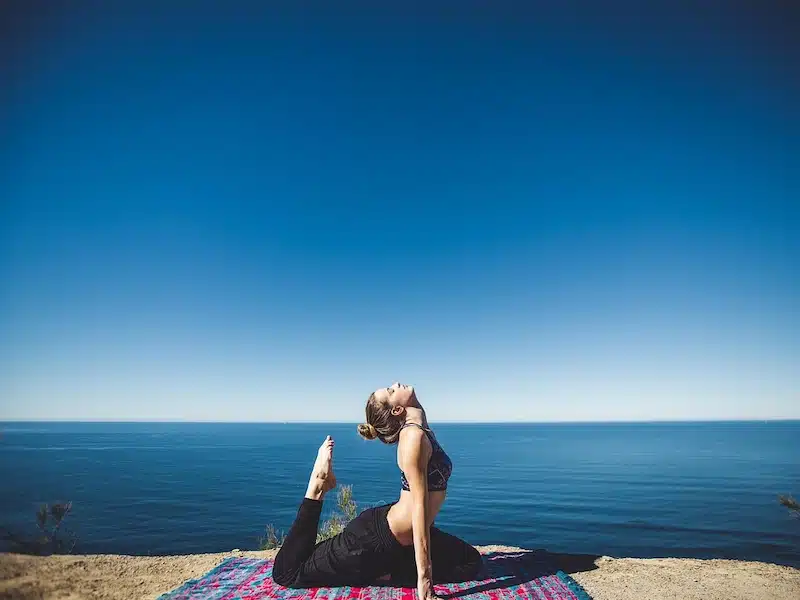 Morning routine woman, yoga, coast, exercise, fitness, lifestyle, ocean, person, relaxing, sea, seaside, shore, stretching, water, workout, nature, wellness, stretch, yoga pose, international yoga day